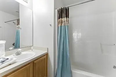 a bathroom with a sink and a shower at Cozy No-Carpet Home Heated Pool Disney in Kissimmee