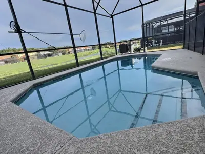 a swimming pool in a building with a roof at Family Getaway wPvt Pool close to Disney in Kissimmee