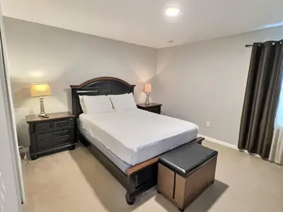 a bedroom with a bed and two nightstands and a bed sidx sidx sidx at Family Getaway wPvt Pool close to Disney in Kissimmee