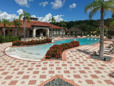 a swimming pool at a resort with a palm tree at Family Getaway wPvt Pool close to Disney in Kissimmee