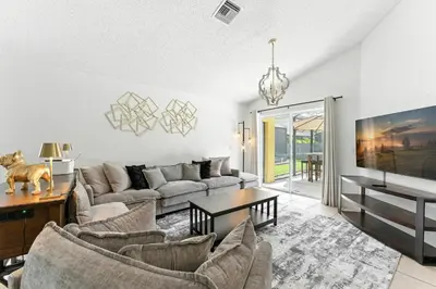 a living room with a couch and a table at Two Master Suites Private Pool in Kissimmee