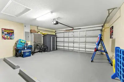 a garage with two garage doors and a bike in it at Two Master Suites Private Pool in Kissimmee