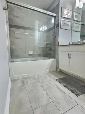 a bathroom with a shower and a bath tub at Family Getaway near Disney Sleeps 13 in Kissimmee
