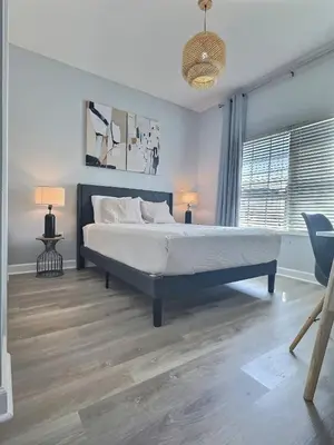 a bedroom with a bed and two lamps in it at Family Getaway near Disney Sleeps 13 in Kissimmee