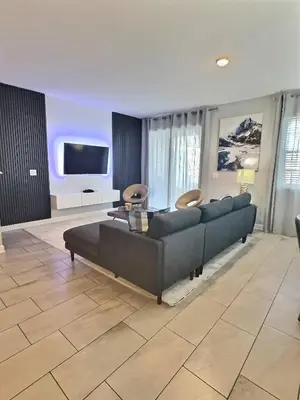 a living room with a couch and a flat screen tv at Family Getaway near Disney Sleeps 13 in Kissimmee