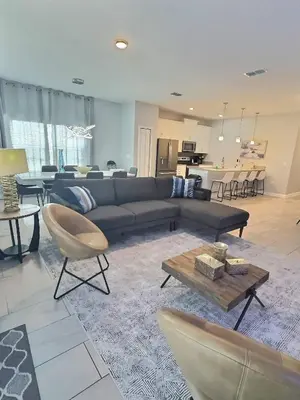 a living room with a couch and a table at Family Getaway near Disney Sleeps 13 in Kissimmee