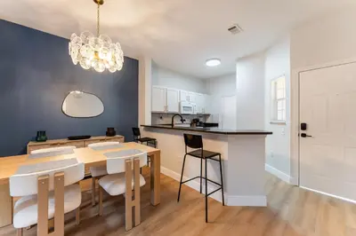 a kitchen and dining room with a table and chairs at Family Townhouse 10 Min to Parks with Themed Room in Kissimmee