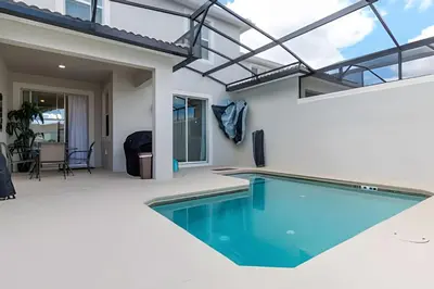 a swimming pool in the middle of a house at Townhouse 4Q em Storey Lake – 10 min da Disney in Kissimmee