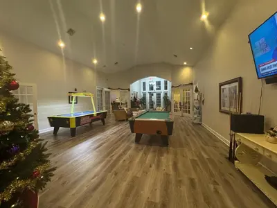 a living room with pool tables and a christmas tree at 4 Bedroom 3 Bathroom Villas At SevenDwarfs 16-101 in Kissimmee