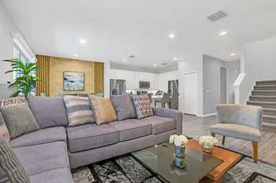 a living room with a couch and a table at Spacious Disney-Area Home with Private Pool in Kissimmee