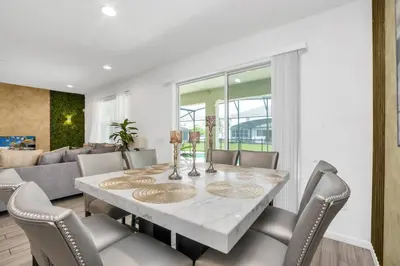 a dining room with a table and chairs at Spacious Disney-Area Home with Private Pool in Kissimmee