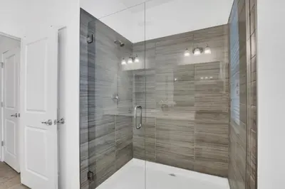 a bathroom with a shower with a glass door at Spacious Disney-Area Home with Private Pool in Kissimmee