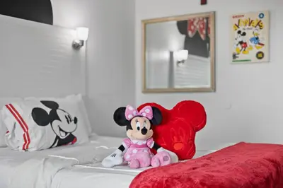 a stuffed animal sitting on a bed with a heart at 2 Bedroom Deluxe - Theme Park in Orlando
