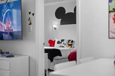 a bedroom with a bed with two stuffed animals on it at 2 Queen Beds Theme Park in Orlando