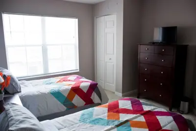 a bedroom with a bed and a dresser and a window at Venetian Bay Townhome townhouse in Kissimmee