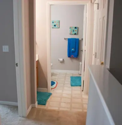 a hallway with a bathroom with a blue towel at Venetian Bay Townhome townhouse in Kissimmee