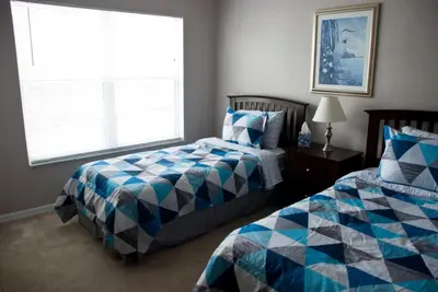 a bedroom with two beds and a window at Venetian Bay Townhome townhouse in Kissimmee
