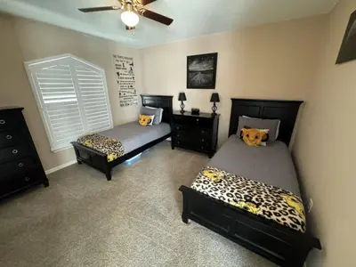 a bedroom with two beds and a ceiling fan at Villa Crayson home in Kissimmee
