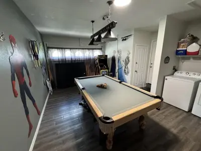a living room with a pool table in it at Villa Crayson home in Kissimmee