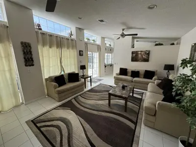 a large living room with couches and a rug at Villa Crayson home in Kissimmee
