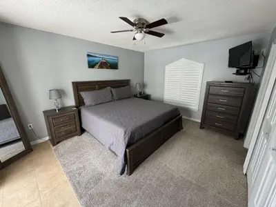 a bedroom with a bed and a ceiling fan at Villa Crayson home in Kissimmee