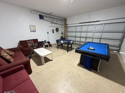 a living room with couches and a pool table at Cullen Villa home in Kissimmee