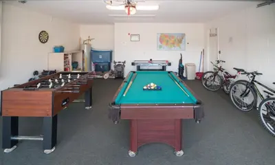 a room with two pool tables and bicycles at Cumbrian Retreat home in Kissimmee