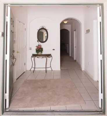 a hallway with a table and a mirror on the wall at Cumbrian Retreat home in Kissimmee