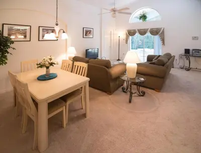 a living room with a table and a couch at Cumbrian Retreat home in Kissimmee