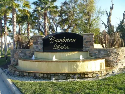 a sign for a fountain in a park with palm trees at Weikva Villa home in Kissimmee