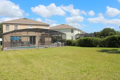 a house with a large gazebo in a yard at Berkeley Pool Home home in Kissimmee