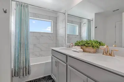 a bathroom with a sink and a tub and a shower at Top House with Private Pool and Resort in Kissimmee