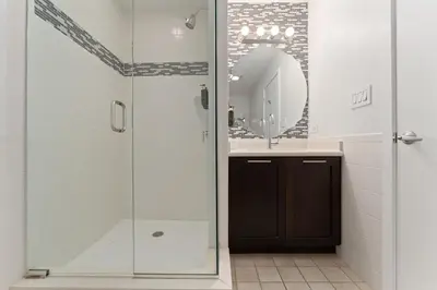 a bathroom with a shower and a sink and a mirror at Hotel Meliá Orlando in Orlando