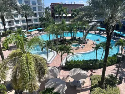 an aerial view of a resort pool with palm trees at Hotel Meliá Orlando in Orlando