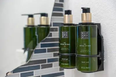 three green bottles of soap on a wall at Hotel Meliá Orlando in Orlando