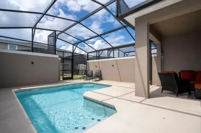 an indoor swimming pool with a glass roof at Casa 4Q Storey Lake c/ Quarto Temático & Piscina in Kissimmee
