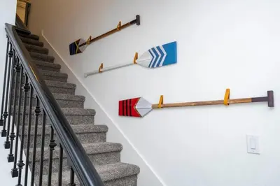 a staircase with umbrellas hanging on a wall at Casa 4Q Storey Lake c/ Quarto Temático & Piscina in Kissimmee
