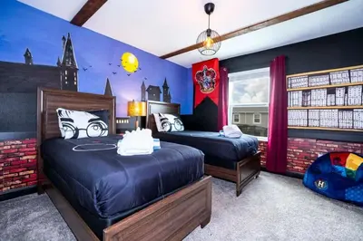 a bedroom with two beds and a castle wall at Casa 4Q Storey Lake c/ Quarto Temático & Piscina in Kissimmee