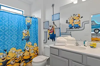 a bathroom with a minion shower curtain and a sink at Casa 6Q Paradiso Grande. Piscina + Sala de Jogos in Orlando