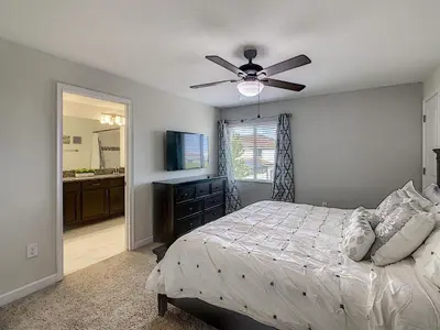 a bedroom with a bed and a ceiling fan at 3065 - 5BR w Pool 10min Disney 2 Water Parks in Kissimmee