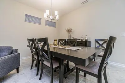 a dining room with a dining table and chairs at 3121#308- 3BR Condo 10min Disney 2 WaterParks in Kissimmee