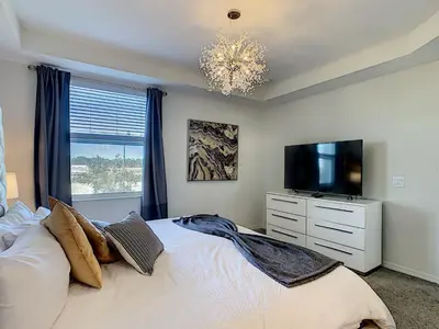 a bedroom with a bed and a tv and a window at 4731#208- 3BR Condo 10min Disney 2 WaterParks in Kissimmee