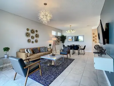 a living room with a couch and a table at 4731#208- 3BR Condo 10min Disney 2 WaterParks in Kissimmee