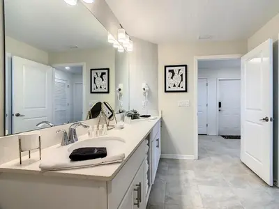 a bathroom with a sink and a large mirror at 4731#301- 3BR Condo 10min Disney 2 WaterParks in Kissimmee