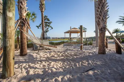 a hammock on the beach with palm trees at 4731#301- 3BR Condo 10min Disney 2 WaterParks in Kissimmee