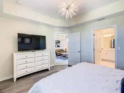 a bedroom with a television and a white dresser at 4731#308- 3BR Condo 10min Disney 2 WaterParks in Kissimmee