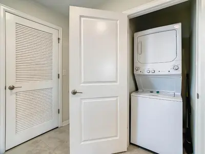 a kitchen with a microwave and a washer and dryer at 4731#308- 3BR Condo 10min Disney 2 WaterParks in Kissimmee