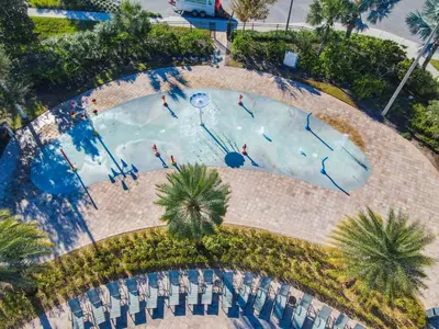 an overhead view of a swimming pool with people in it at 4766 - 5BR w Pool 10min Disney 2 Water Parks in Kissimmee