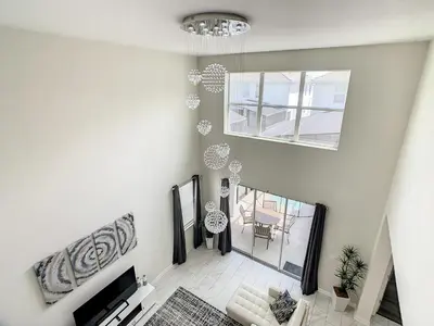 an overhead view of a living room with a chandelier at 4766 - 5BR w Pool 10min Disney 2 Water Parks in Kissimmee