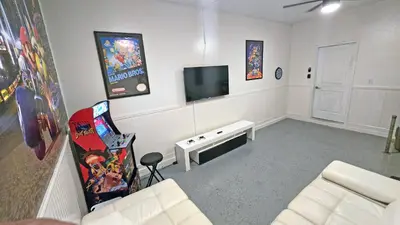a living room with a couch and a tv at 4774 - 7BR w Pool 10min Disney 2 Water Parks in Kissimmee